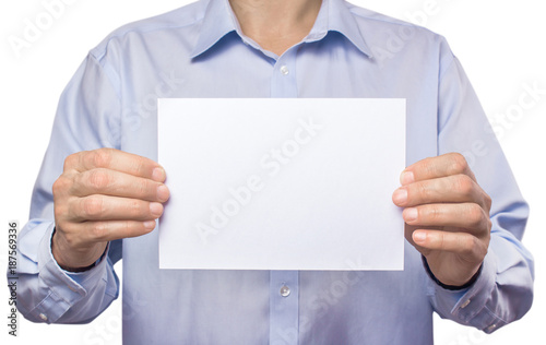 The men in the shirt are holding an empty white sheet of paper A5. Isolated on white background. Mockup, template