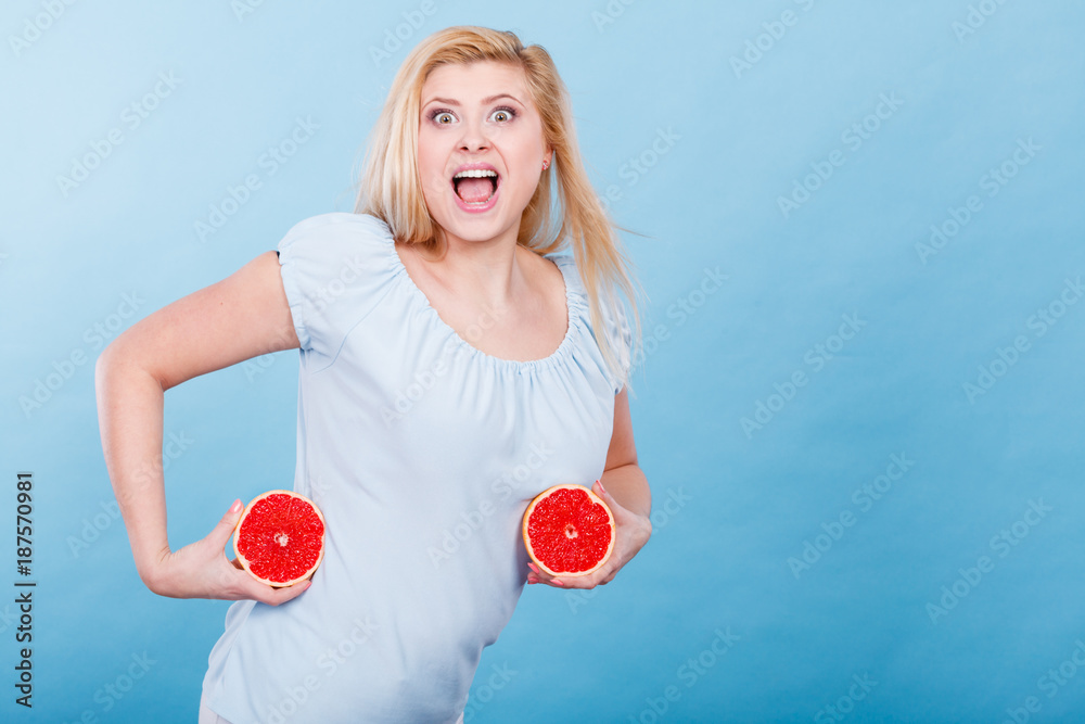 Woman holds grapefruit citrus fruit in hands Woman holds grapefruit citrus fruit in hands