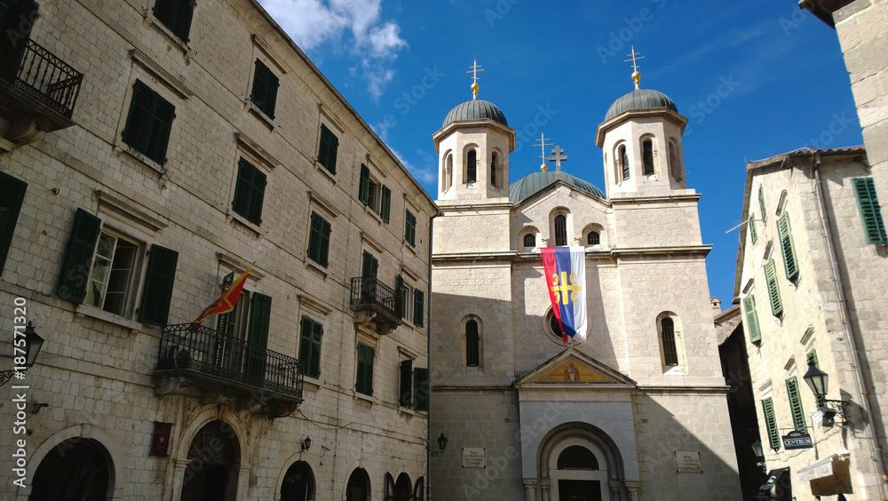 The old Cathedral and the facade of the house with shutters in the old town of Kotor, in Montenegro
