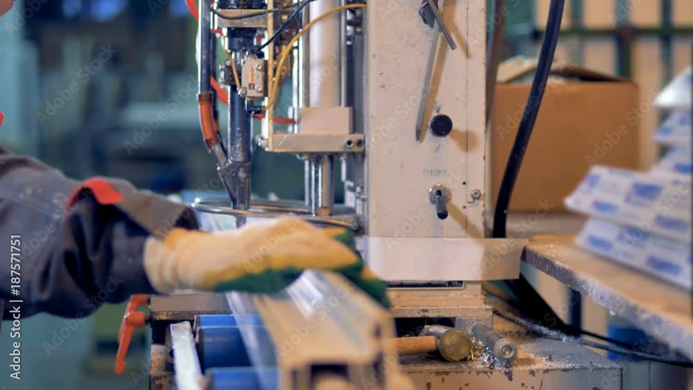 A worker manually installs window profile for machine pressing. A worker manually installs window profile for machine pressing.