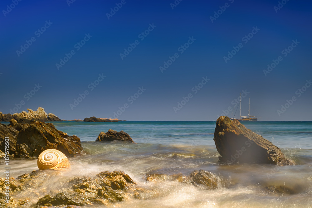 Fototapeta premium Lolantonis beach at Paros island. Long exposure with a seashell at the foreground. 