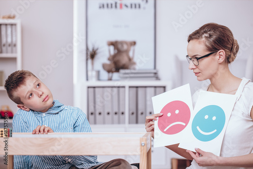 Counselor teaching autistic kid