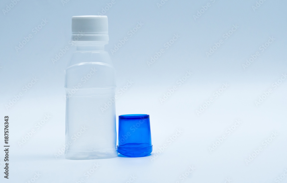 Sterile eye lotion in white plastic bottle with blue eyebath and copy space and blank label. Eye wash after contact pollution environment or after swimming in chlorine contaminate pool. Sterile eye lotion in white plastic bottle with blue eyebath and copy space and blank label. Eye wash after contact pollution environment or after swimming in chlorine contaminate pool.