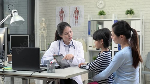 doctor and girl and mom using the digital tablet