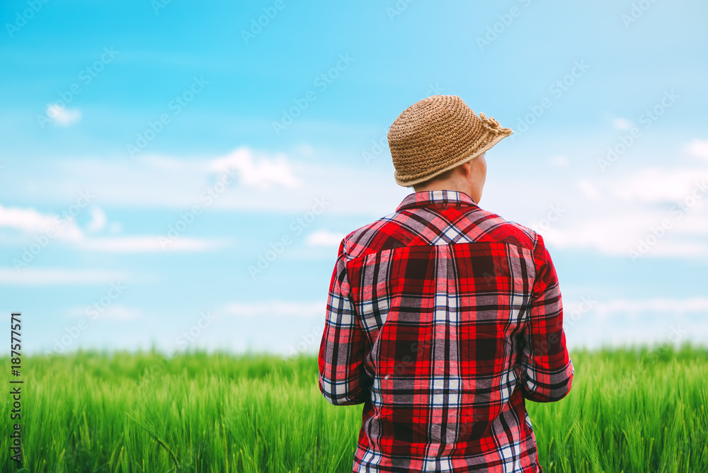 Concept of responsible farming, female farmer in cereal crops field