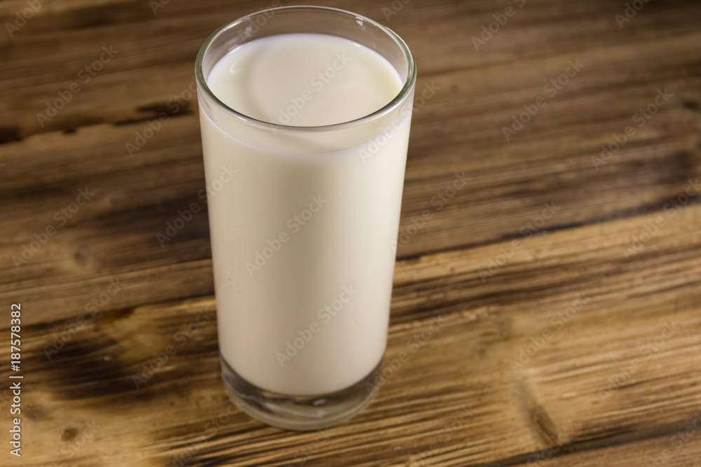 Glass of milk on wooden table Glass of milk on wooden table