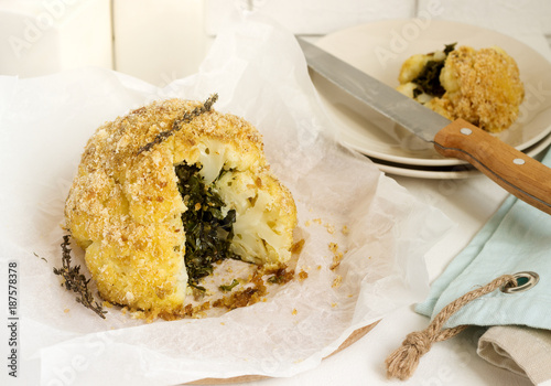 Stuffed cauliflower with chard and bread crumbs. Rustic style. photo