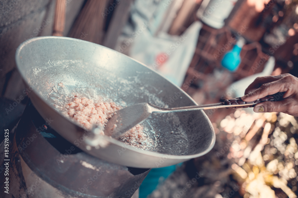Fototapeta premium Coconut cooking in a pan, San Jose, Philippines