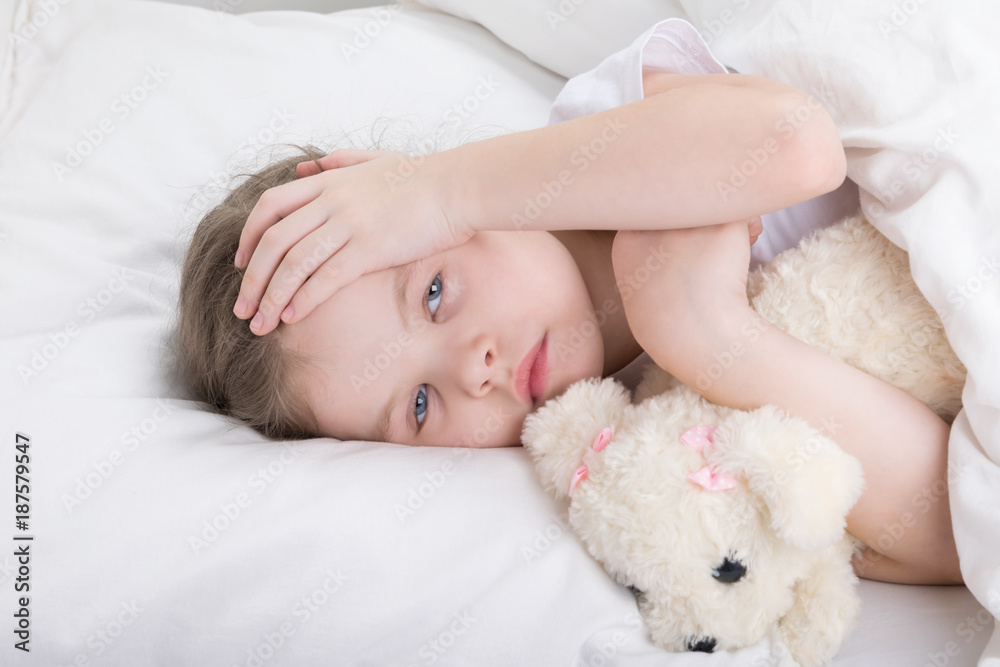 child in a white bed complains of a headache child in a white bed complains of a headache