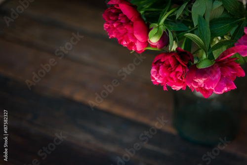 Beautiful  bunch of peony on a wooden table. Spring or summer lovely bouquet. Card, text place, copy space. Wallpaper, trendy color.