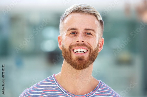 handsome young man with beard laughing