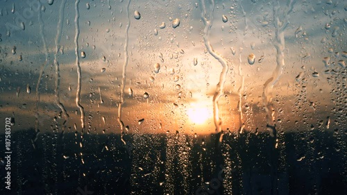 Beautiful sunrise while raining. Watching the sunrise behind the window. 4K