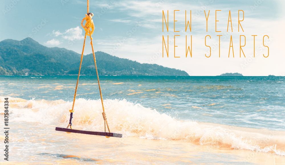 Swing on the beach with text New Year New Starts