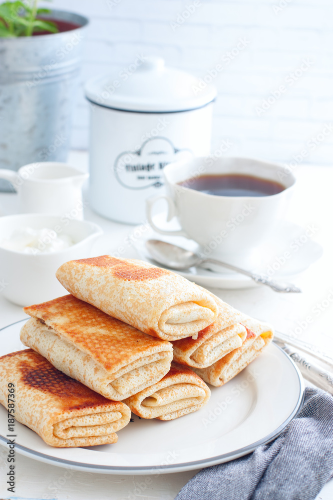 Stuffed pancakes on a white plate, selective focus Stuffed pancakes on a white plate, selective focus
