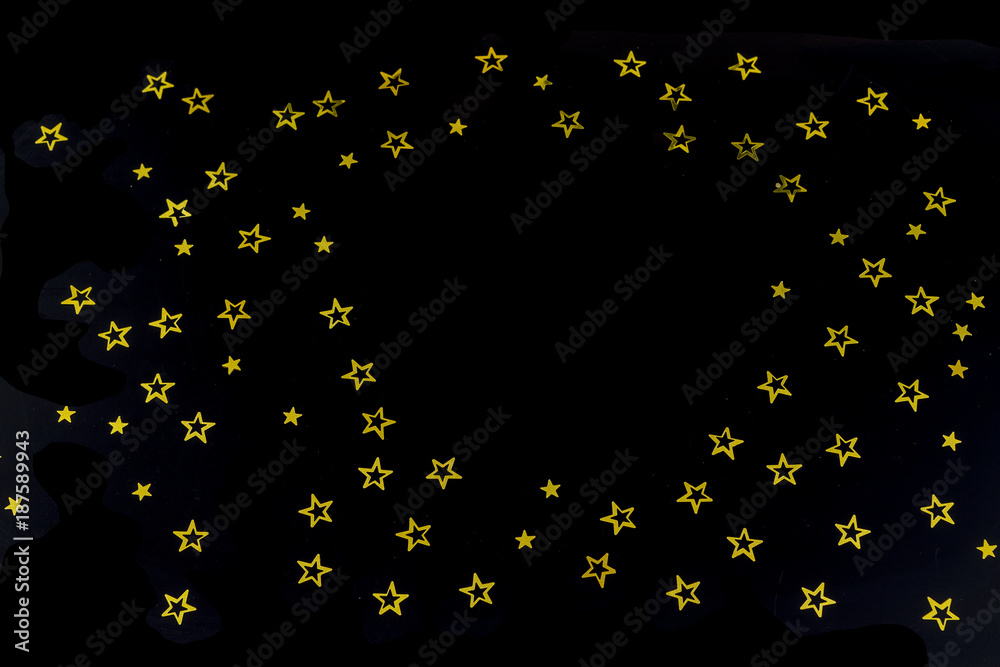 background of golden glitter particles stars on black background,happy with copy space on the middle background of golden glitter particles stars on black background,happy with copy space on the middle