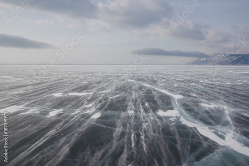 view of ice water surface under cloudy sky during daytime, russia, lake baikal © LIGHTFIELD STUDIOS