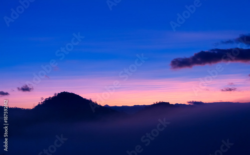 Beautiful orange light on mist mountain of fog when sunrise time. Mountain landscape in the north of Thailand