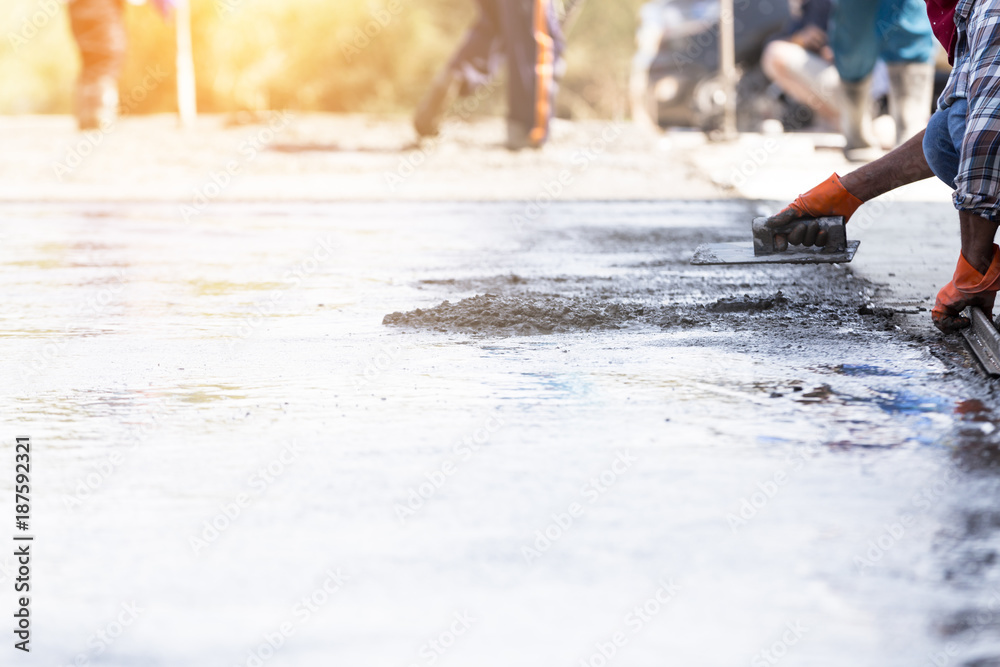 Industry construction men workers with tool concrete mix on road construction Industry construction men workers with tool concrete mix on road construction