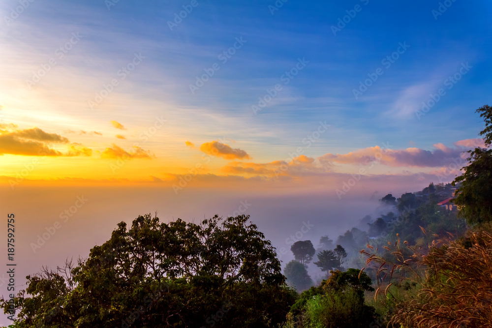 Beautiful orange light on mist mountain of fog when sunrise time. Mountain landscape in the north of Thailand