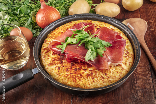 A closeup photo of a Spanish tortilla with ingredients