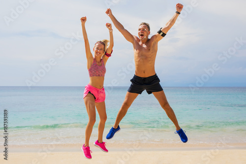 Fit couple feeling great after completed workout on the beach 