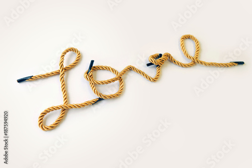Golden color rope makes handwriting word of Love on white background