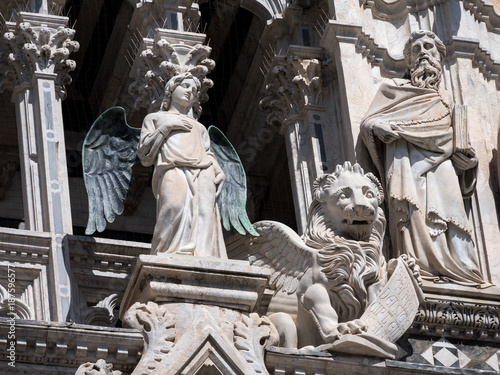 Statues of angel, lion and philosopher at Siena Cathedral