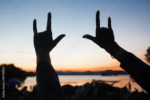 Silhouette of hand sign "I LOVE YOU" with twilight sky in background, Love and Valentines concept