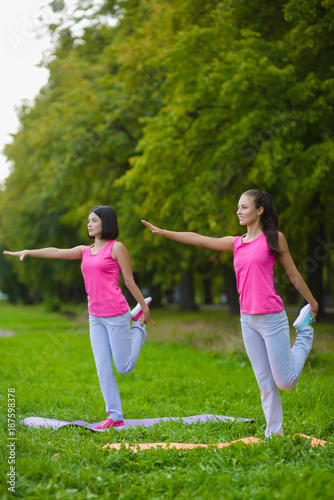 Fitness sport girls in sportswear doing yoga fitness exercise outdoor