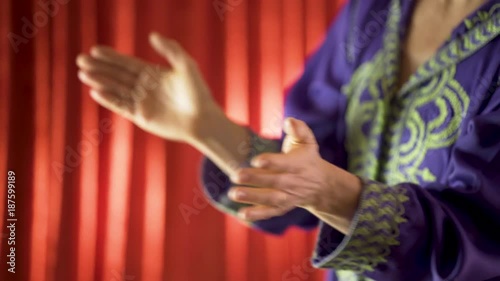 Closeup of woman clapping rhythmically in a mechanical fashion. photo