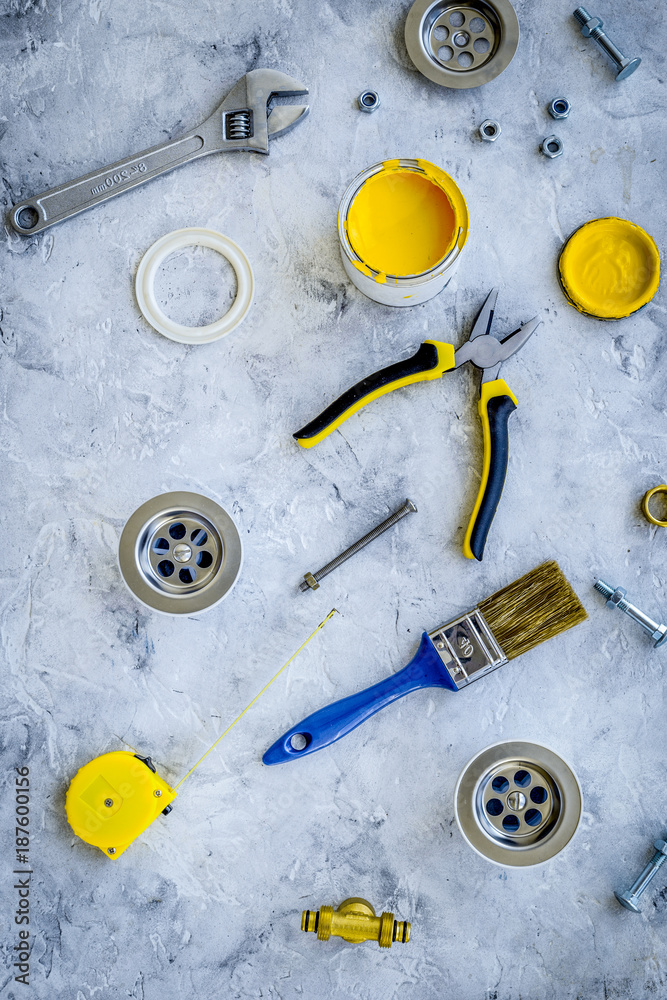 Plumber tools on grey stone background top view Plumber tools on grey stone background top view