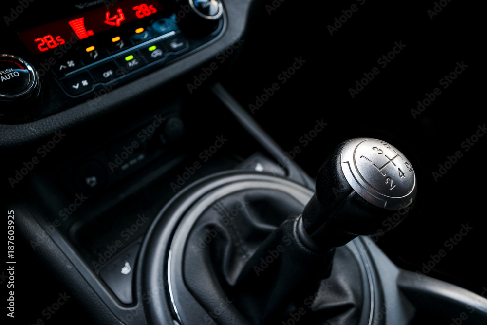 Close up view of a gear lever shift. Manual gearbox. Car interior details. Car transmission. Soft lighting. Abstract view.