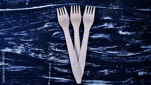 Silver fork lying on a wooden table. Cutlery for eating. Device  photo