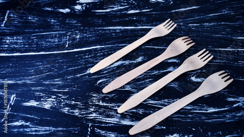 Silver fork lying on a wooden table. Cutlery for eating. Device  photo