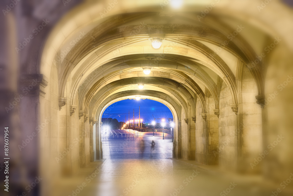 Obraz premium Shadows of people walking at night under ancient medieval loggias