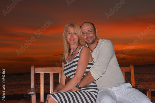 Beautifull forty five years old couple on the beach at sunset