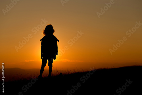 Contours of a child watching the sunset