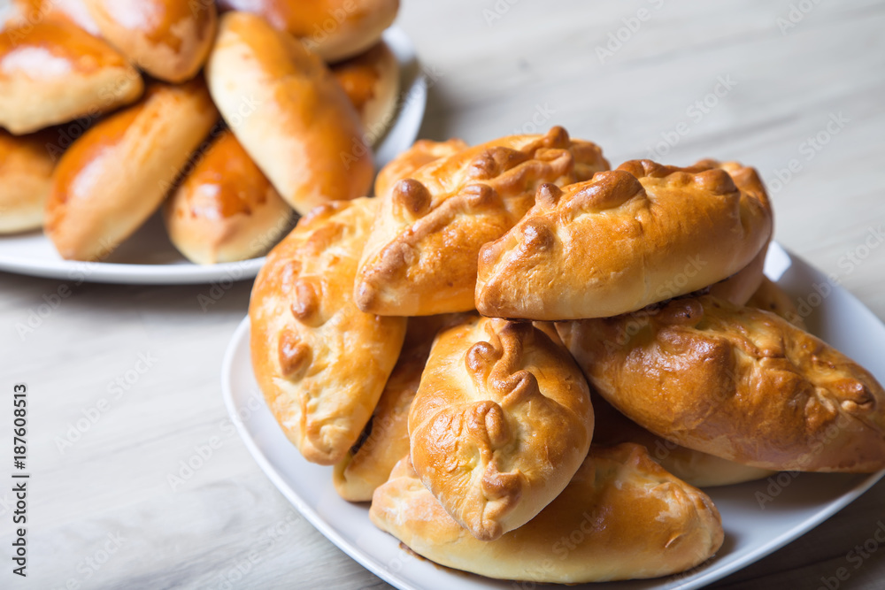Traditional Russian baked pies (pirozhki). Close-up, selective focus.
