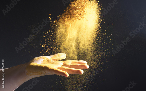 Turmeric spice being thrown into the air 