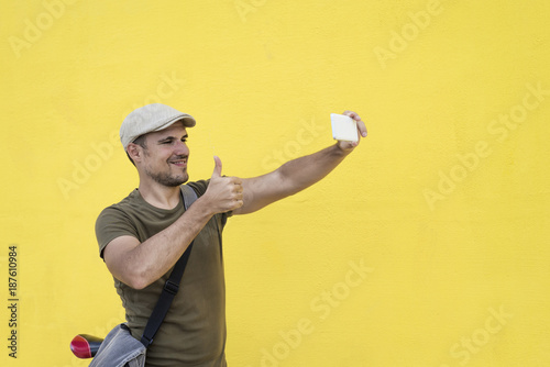 Funny man taking selfie and showing thumb up.