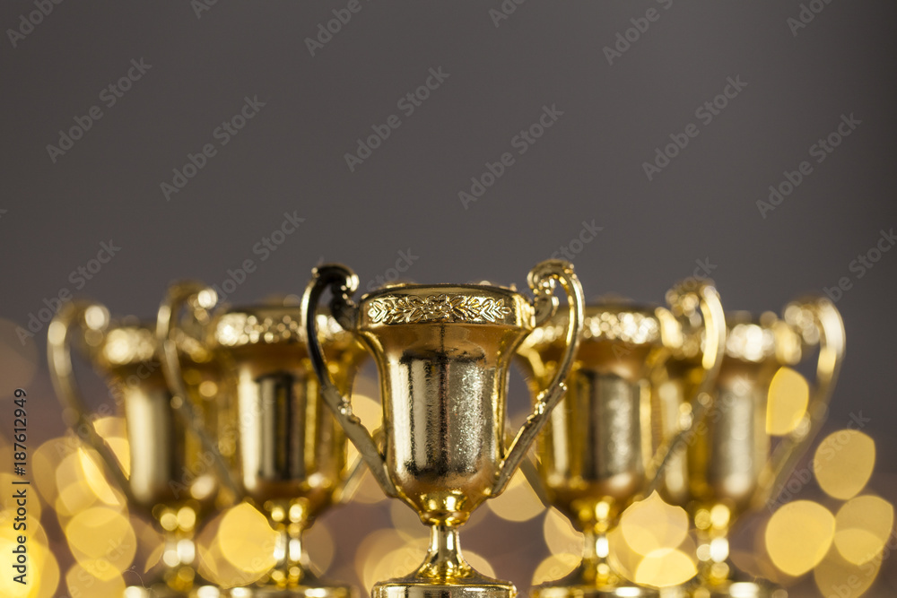 Gold award trophy against bright blurred lights Gold award trophy against bright blurred lights