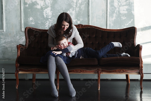 Mom and son on an old sofa photo