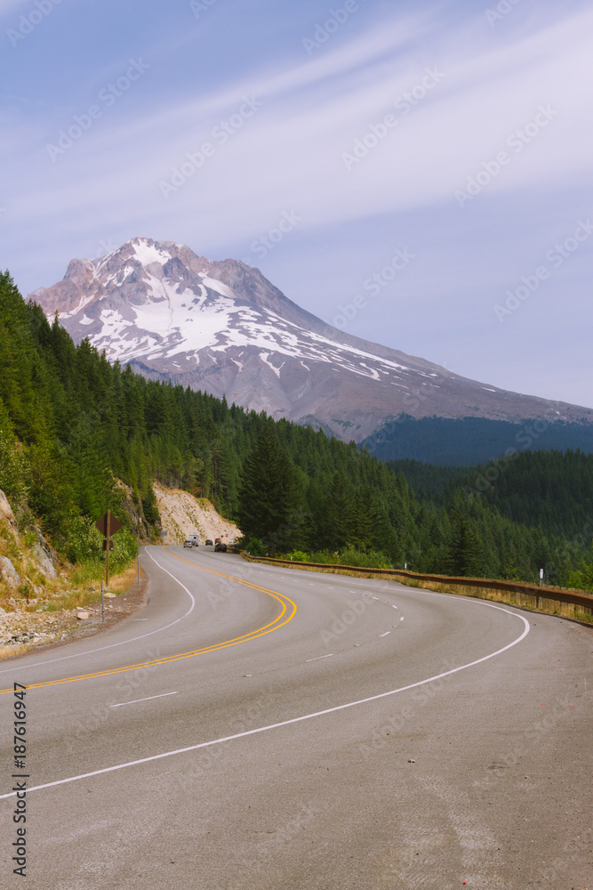 Highway road in mountains with Mt. Hood in the background in Oregon, USA