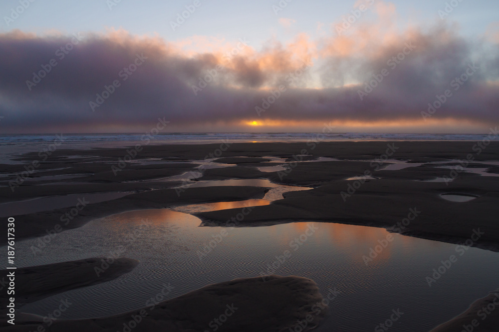 Colorful sunset above sand beach in bayocean peninsula park oregon, USA