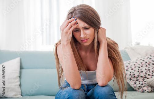 Woman at home suffering from headache, emotions and stress