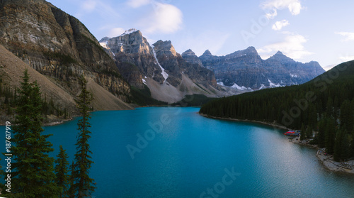 Blue water of Moraine Lake in Rocky Mountains in Canada during colorful sunset