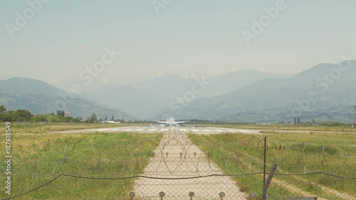 Airplane landing in the mountains of Batumi city, Georgia photo