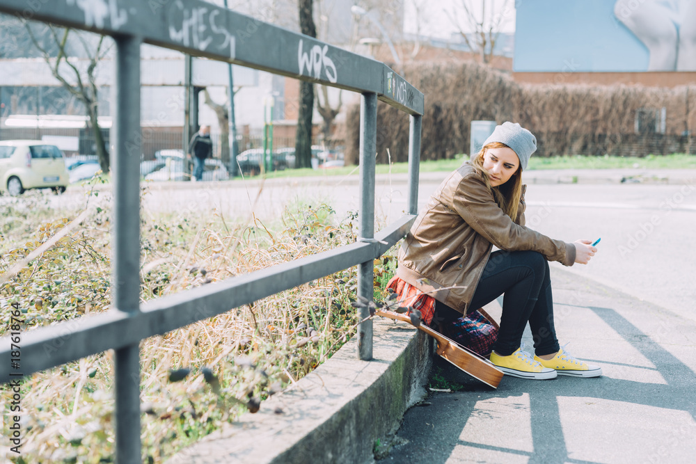 Young woman outdoor using smart phone hand hold looking away - technology, social network, phubbing concept Young woman outdoor using smart phone hand hold looking away - technology, social network, phubbing concept