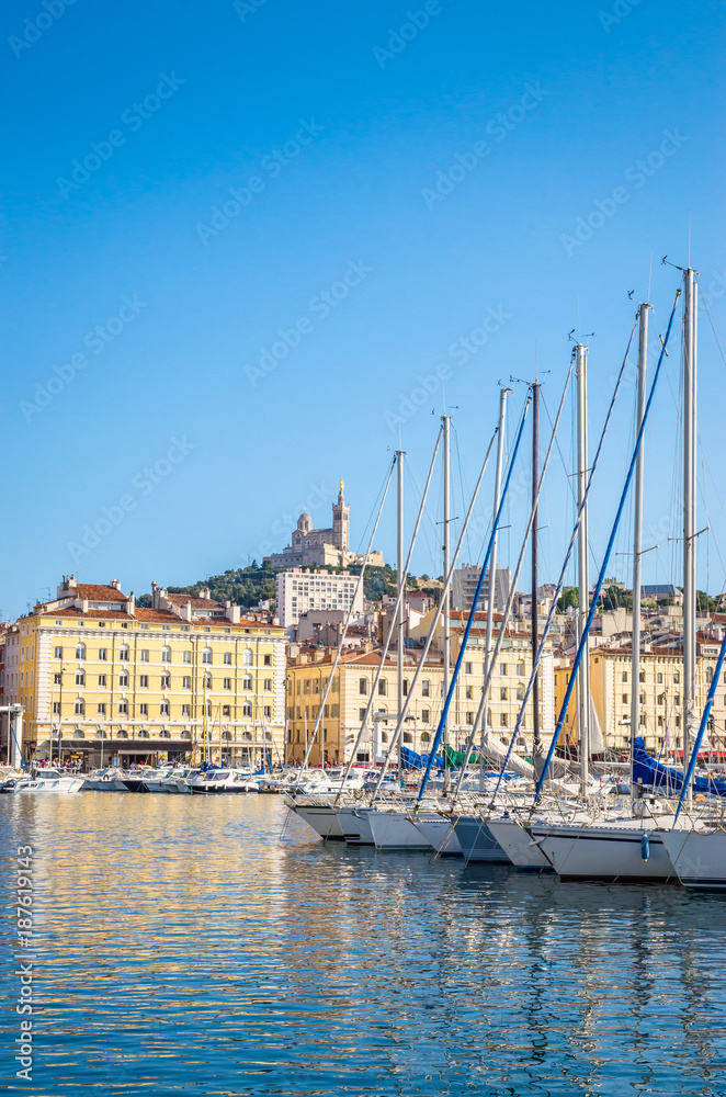 Summer view on basilica of Notre Dame de la Garde and old port in Marseille, France