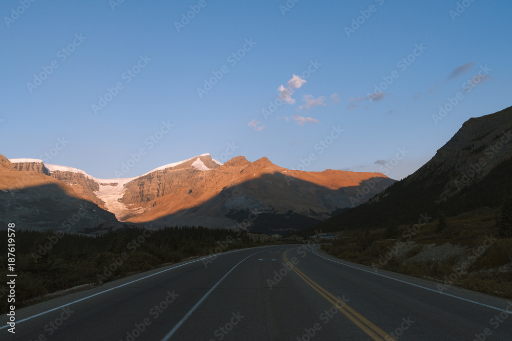 Scenic Icefields Parkway with sunrise light on mountains in Jasper, Canada